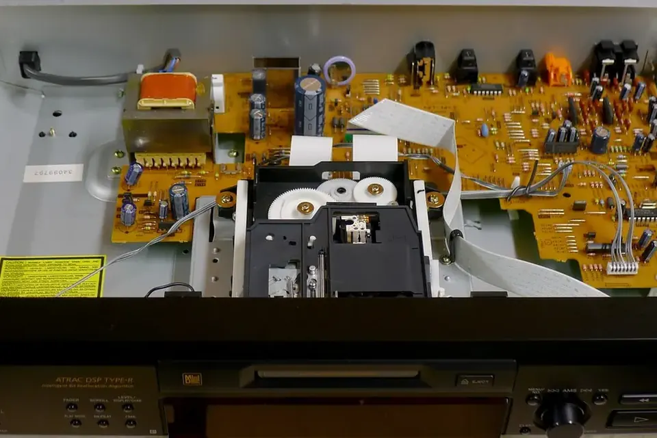 A MiniDisc deck with its top cover removed, showing the disc mechanism and circuit boards
