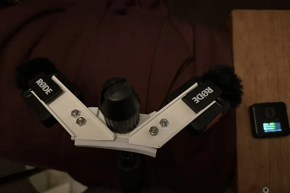 A home-made bracket holding two small microphones angled apart in an ORTF-style arrangement