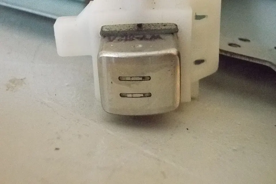 Close-up of a single tape head in its mount, with two short track gaps visible on its polished face